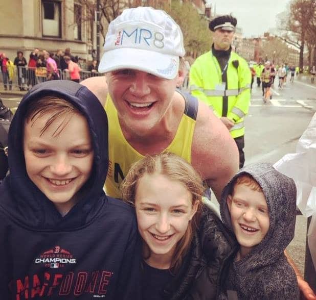Dave Gilmartin with his three kids in the middle of running the Boston Marathon
