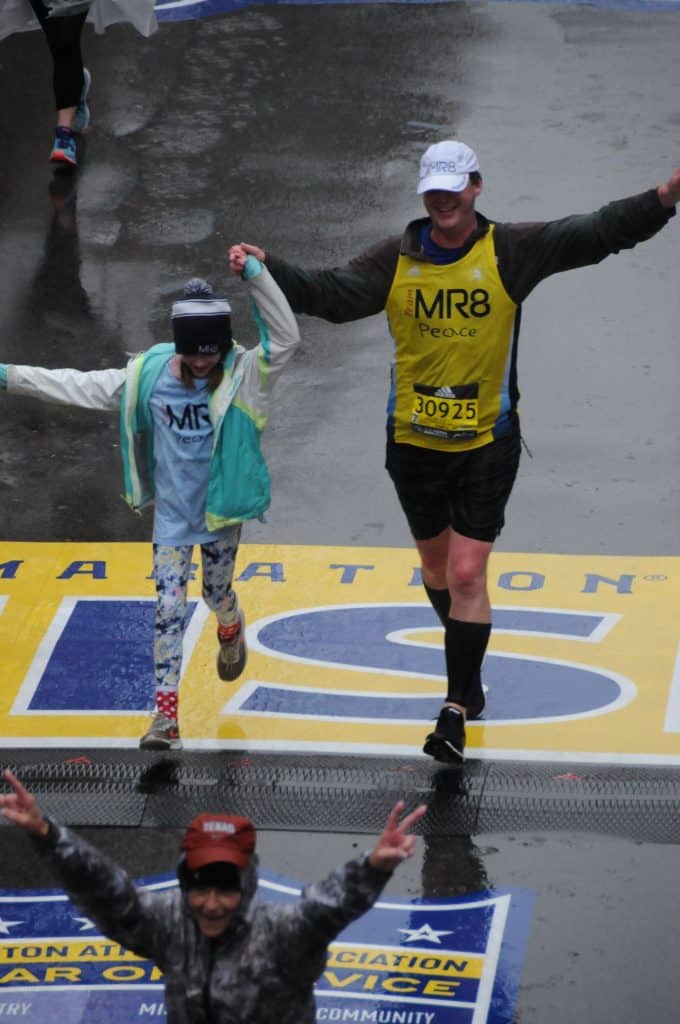Dave Gilmartin and his daughter crossing the finish line of the Boston Marathon